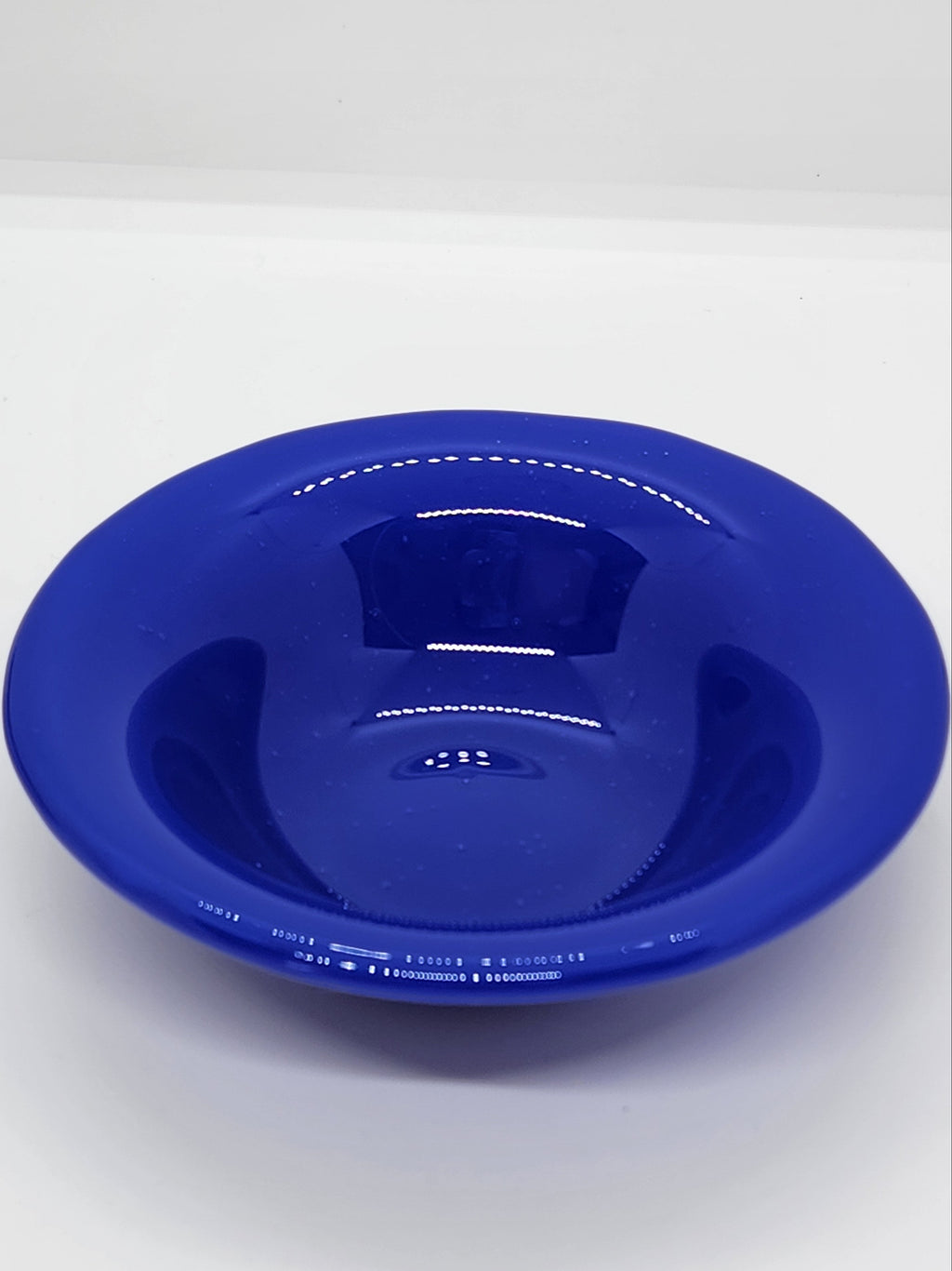 A small trinket glass bowl in cobalt blue.