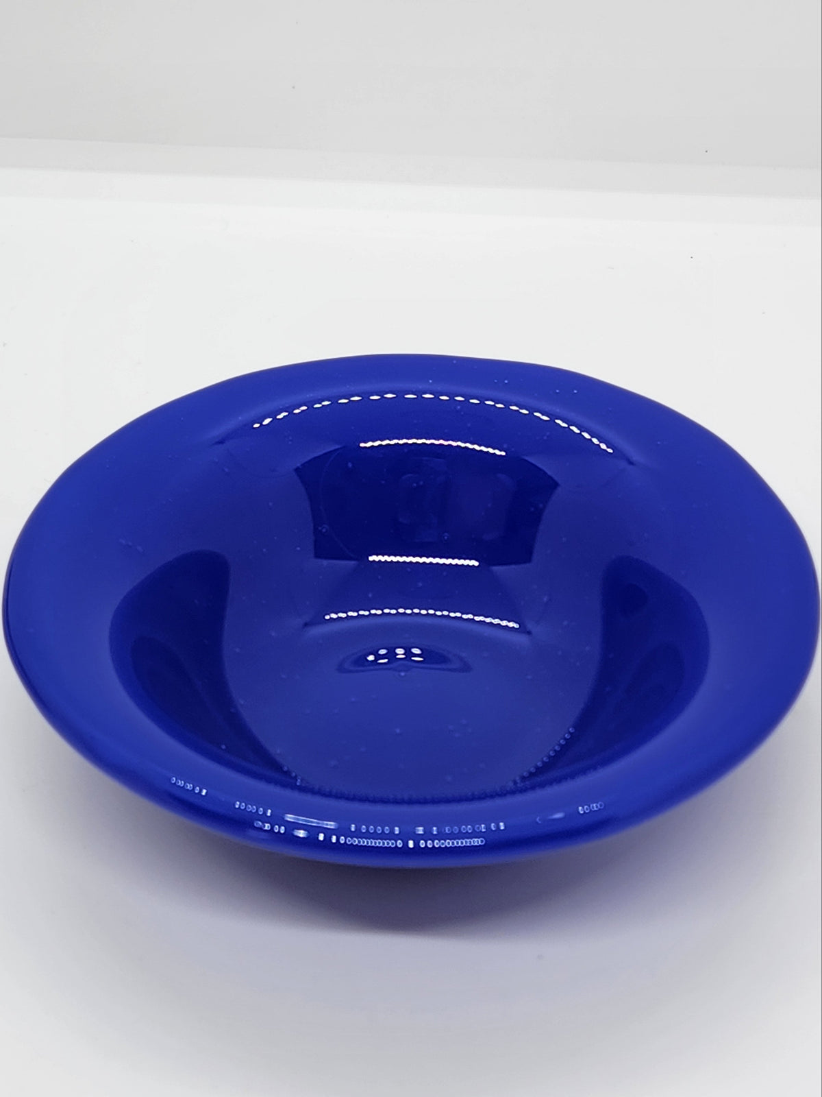 A small trinket glass bowl in cobalt blue.