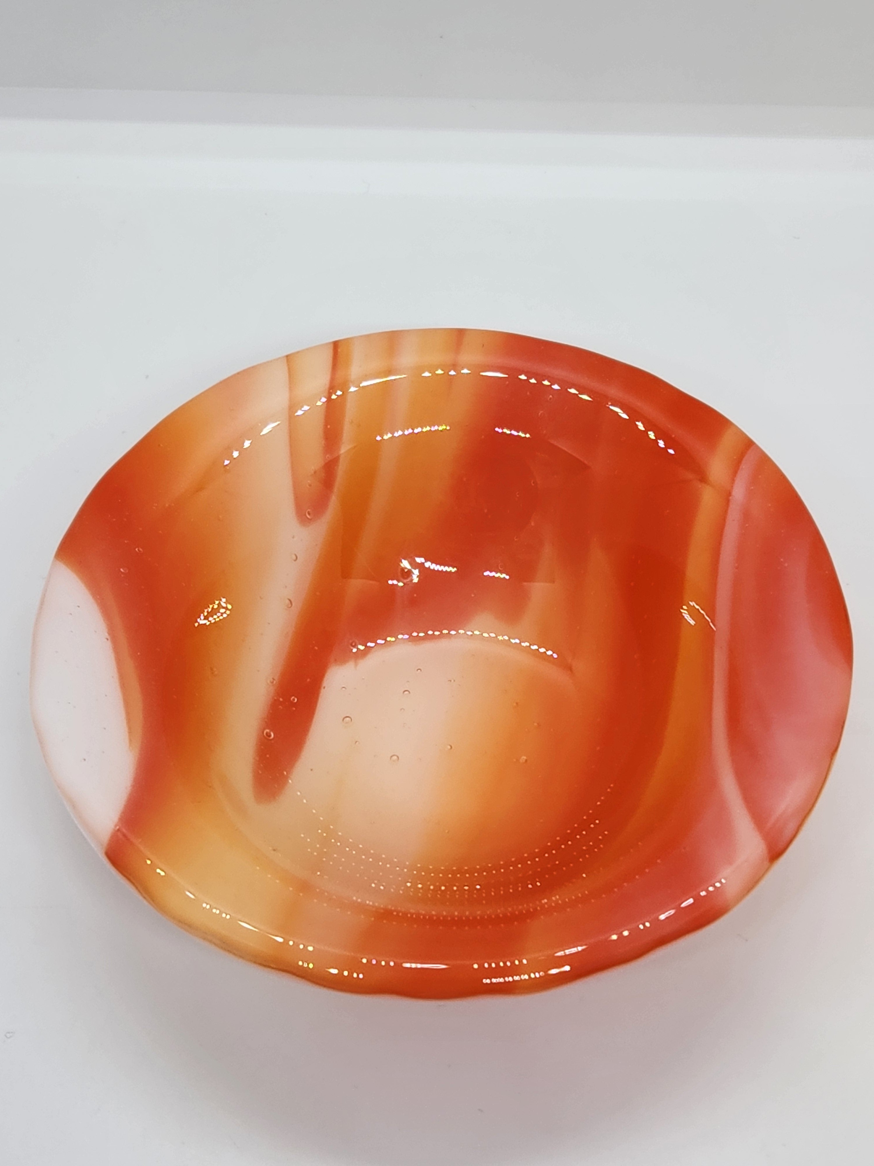 An orange and white marbled glass trinket dis