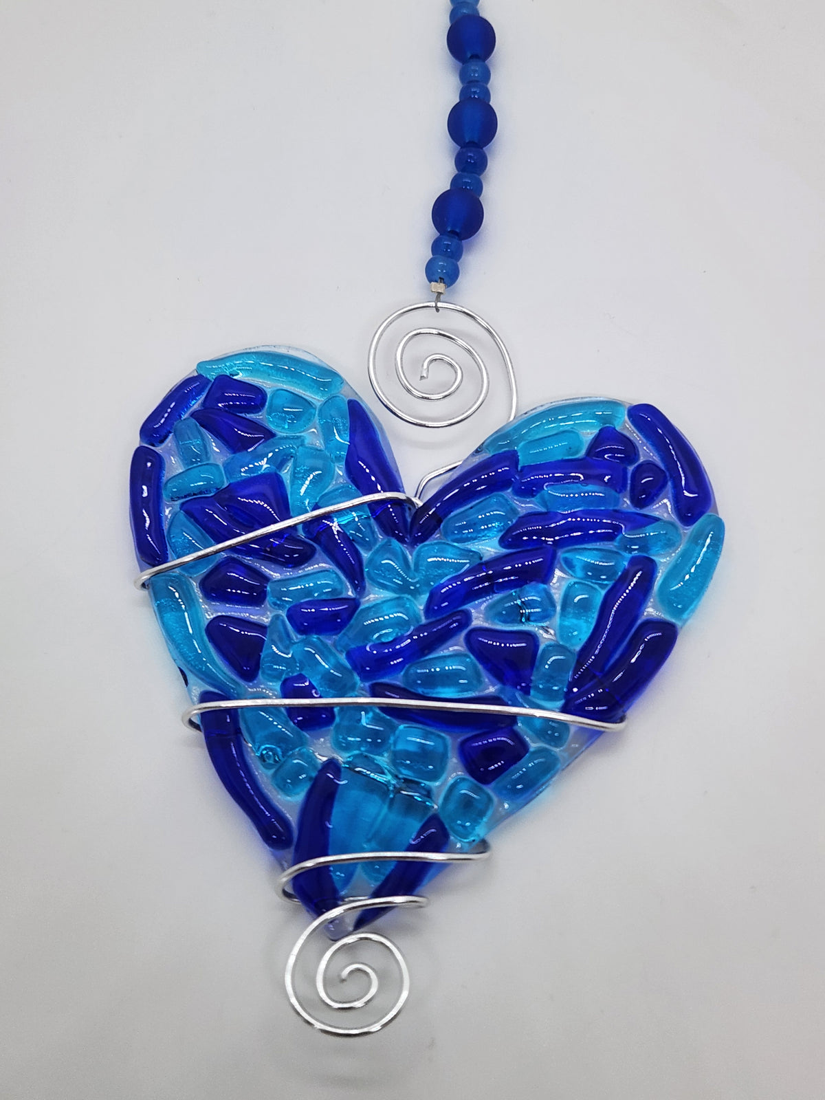 Blue heart suncatcher wrapped in copper wire with bead handle.