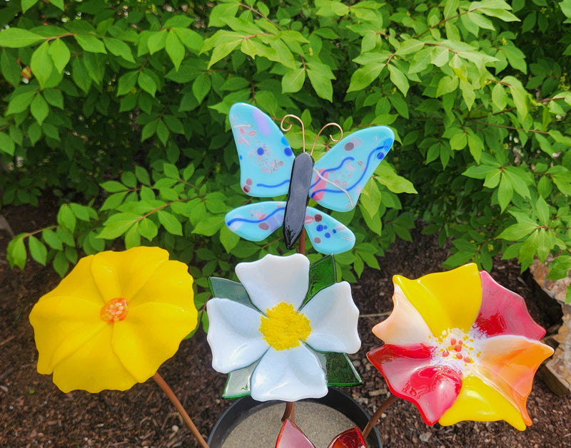 Glass pinwheel garden decor on copper wire.