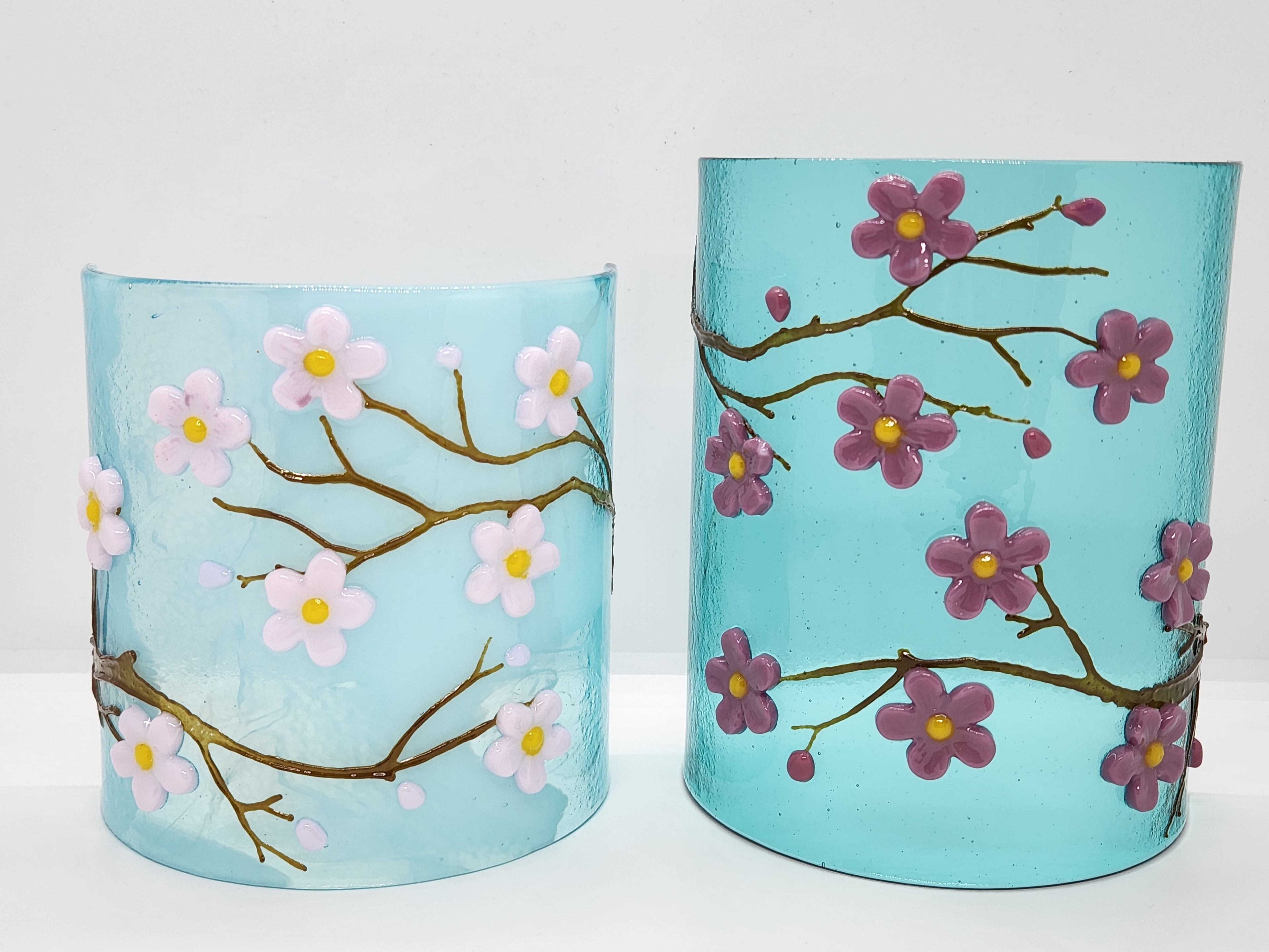 Fused glass Cherry Blossom Candle Curve with delicate white and purple blossoms on an aqua background, designed for displaying LED candles, candles, or as floral home decor.