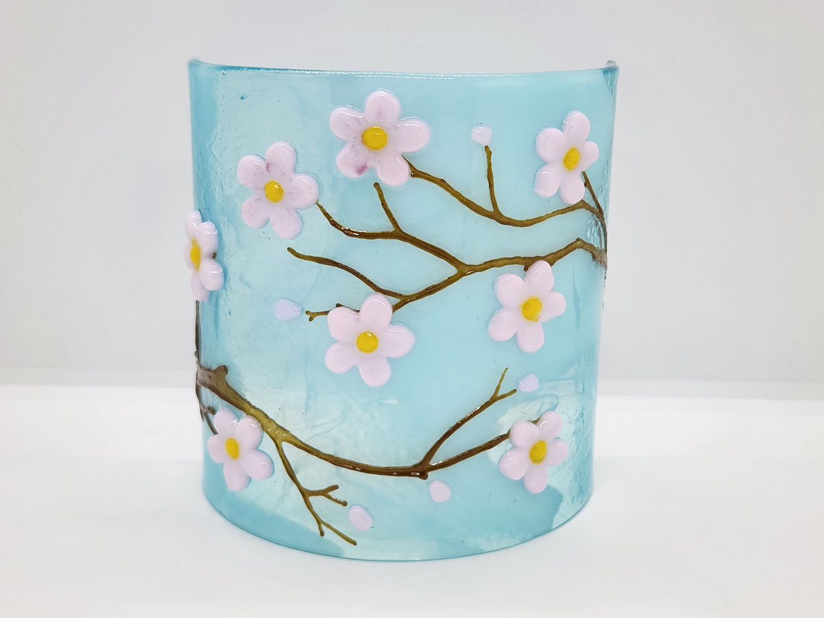 Fused glass Cherry Blossom Candle Curve with delicate white blossoms on an aqua background, designed for displaying LED candles, candles, or as floral home decor.