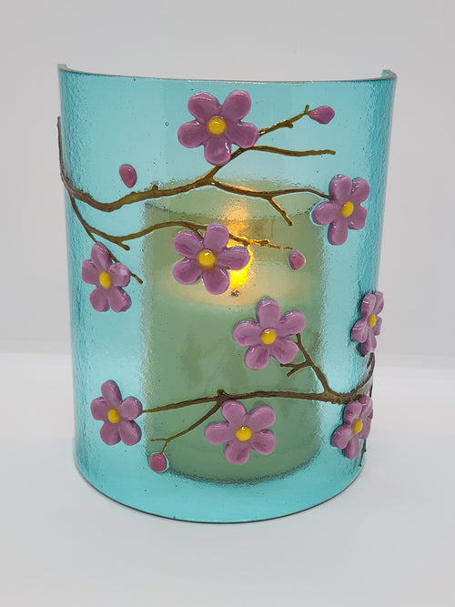 Fused glass Cherry Blossom Candle Curve with delicate pink and purple blossoms on an aqua background, designed for displaying LED candles, candles, or as floral home decor.