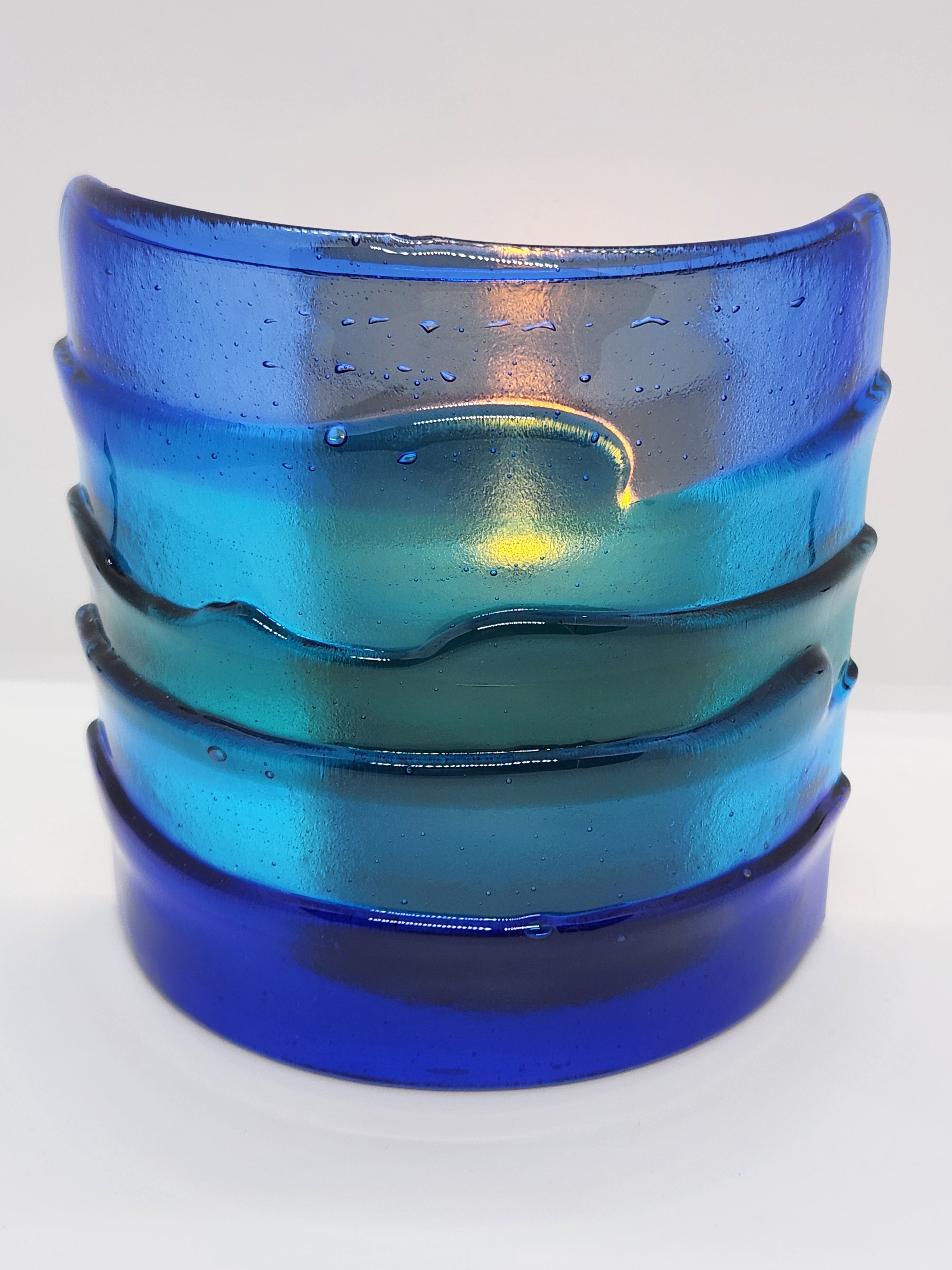 Blue fused glass Landscape Luminary with layered translucent glass designed to display candlelight or brighten a windowsill with soft natural light.