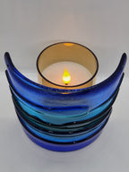 Blue fused glass Landscape Luminary with layered translucent glass designed to display candlelight or brighten a windowsill with soft natural light.