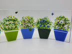 Fused glass Flower Pot Waves featuring blue and green flower pots with blooming greenery on a gently curved glass panel for home decor.
