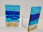 Fused glass Ocean Aqua candle holder with layered aqua, deep blue, and sandy glass, inspired by the colors of the shoreline and designed for home decor.