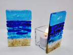 Fused glass Ocean Aqua candle holder with layered aqua, deep blue, and sandy glass, inspired by the colors of the shoreline and designed for home decor.