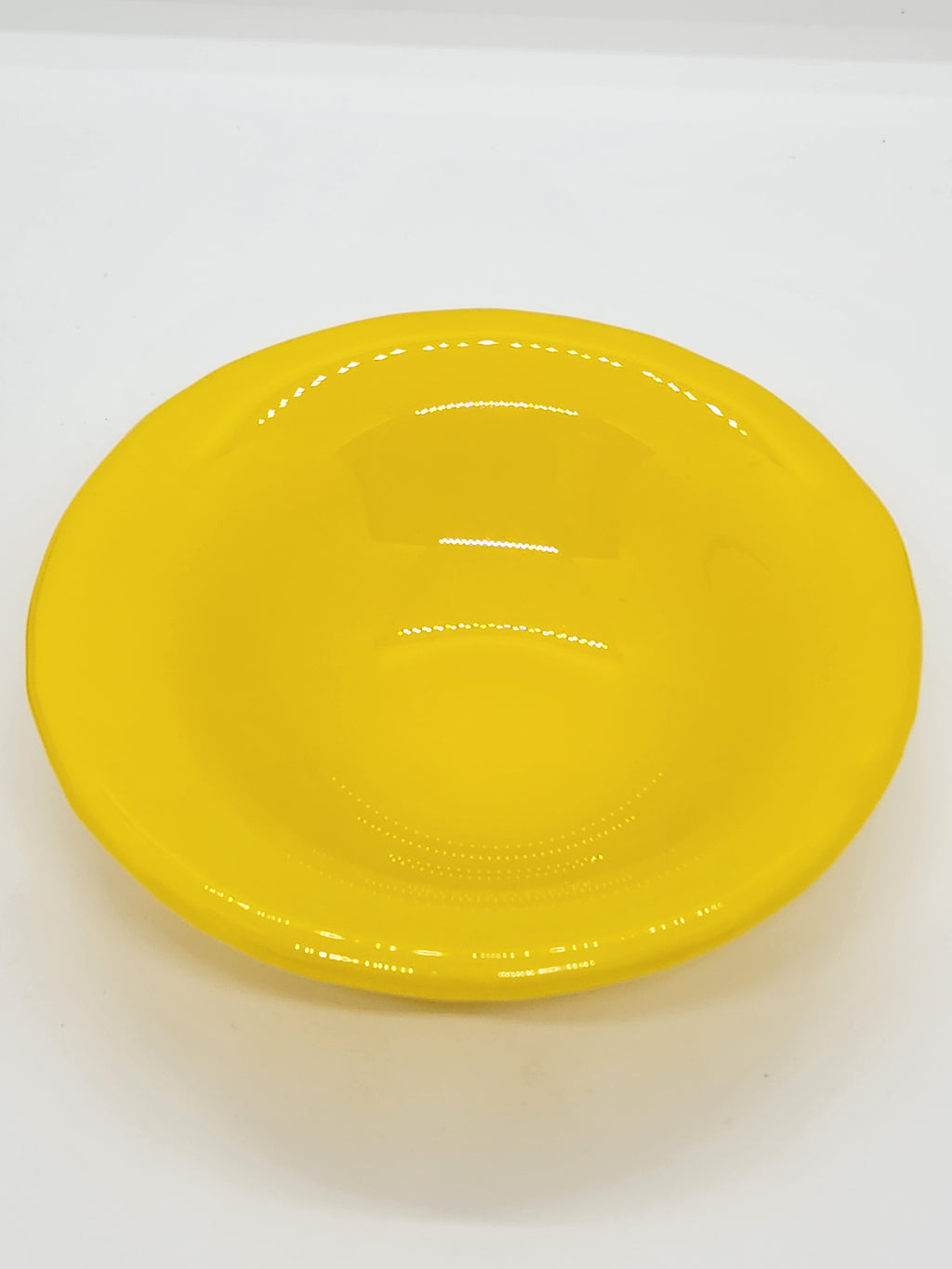 A bright yellow trinket dish with a glossy finish.