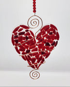 Red heart suncatcher wrapped in copper wire with bead handle.