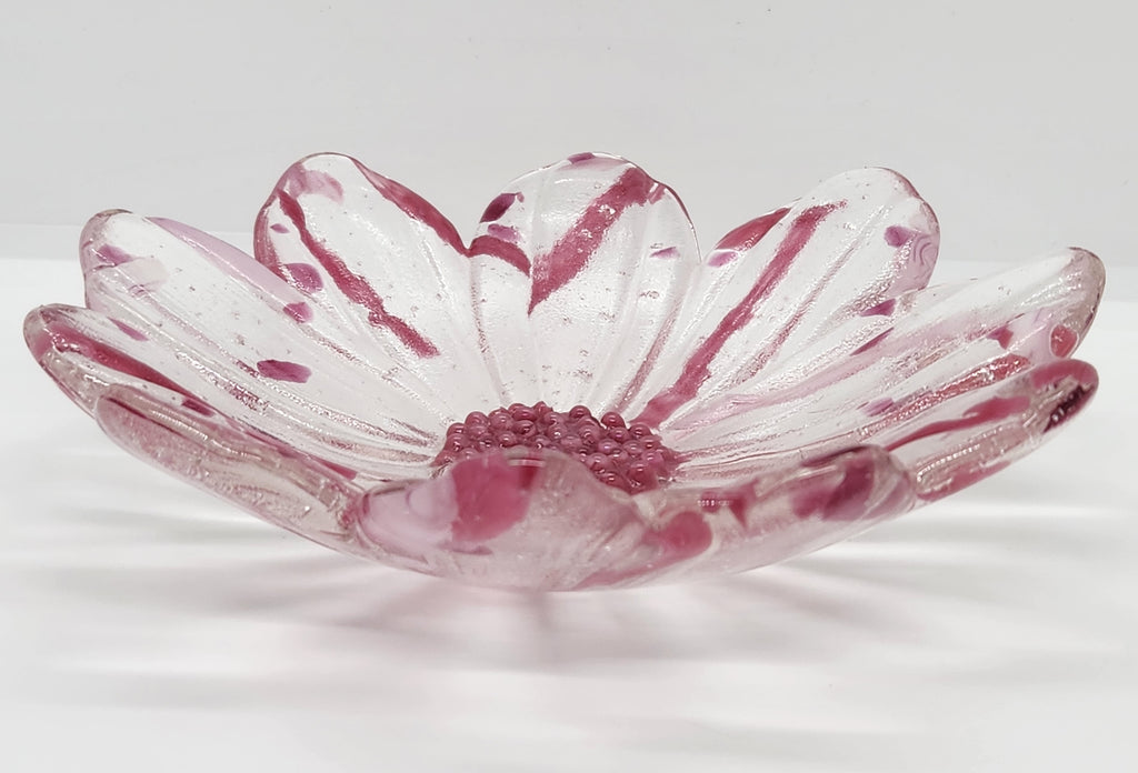 clear glass bowl with pink accents and a pink center on a white background.