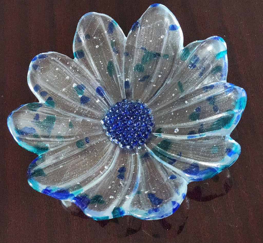 clear and blue glass bowl with a blue center on a brown background